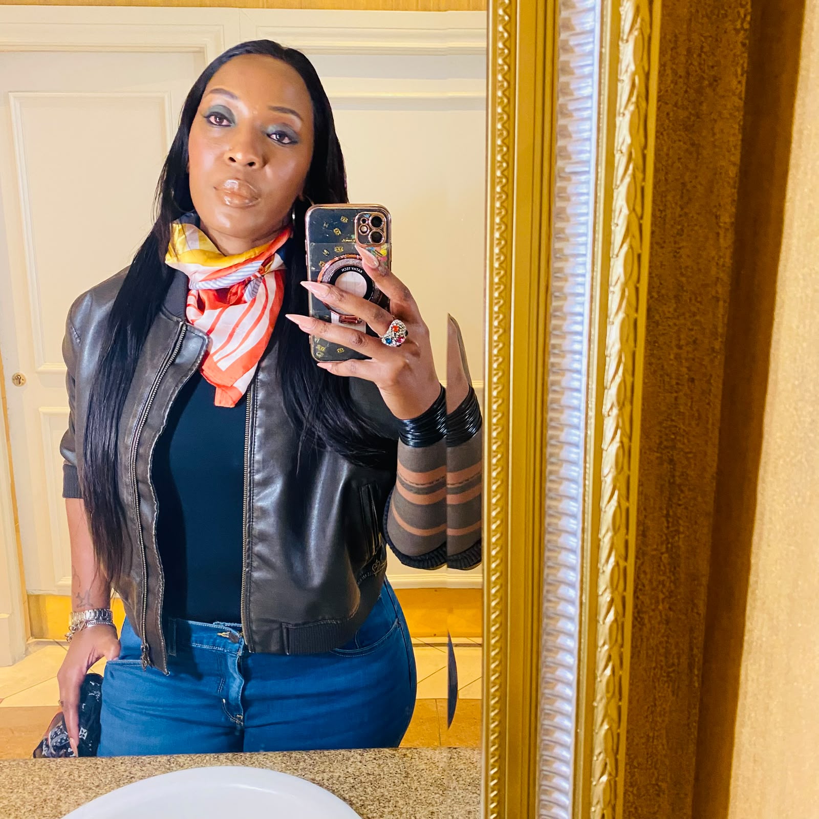 Jerrita in a leather jacket and silk scarf
