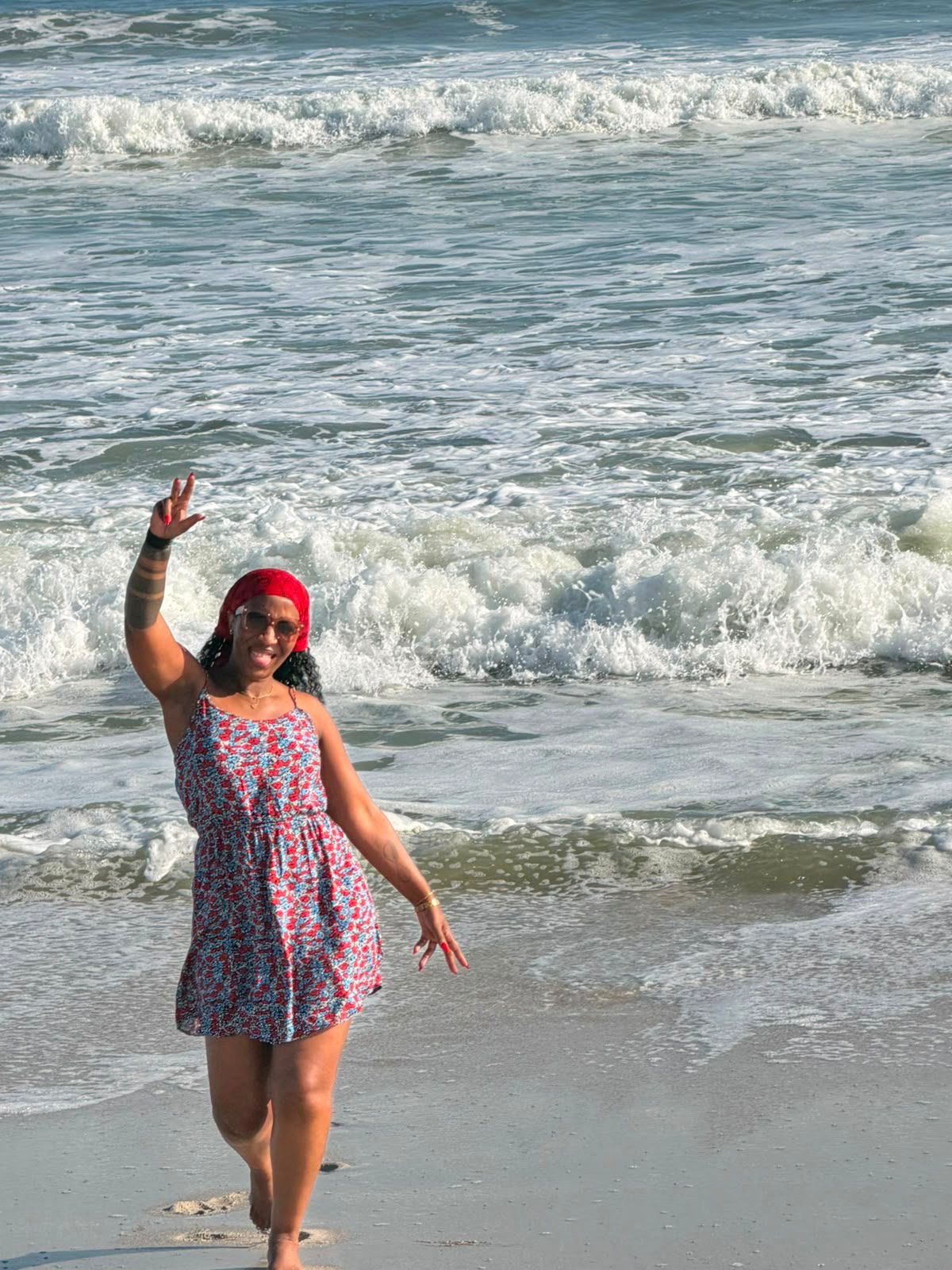Jerrita waving at the shoreline