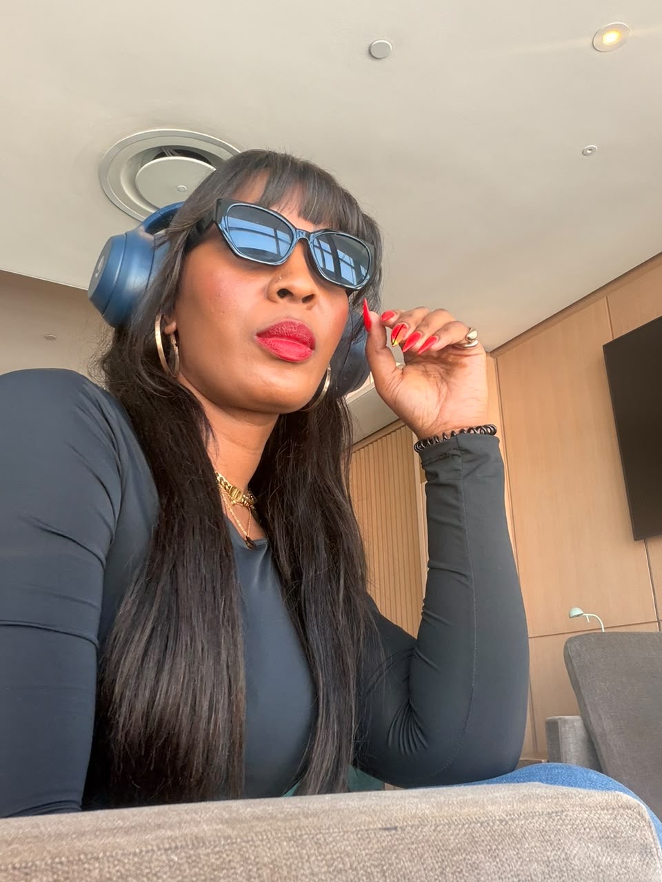 Jerrita in sunglasses and headphones, listening