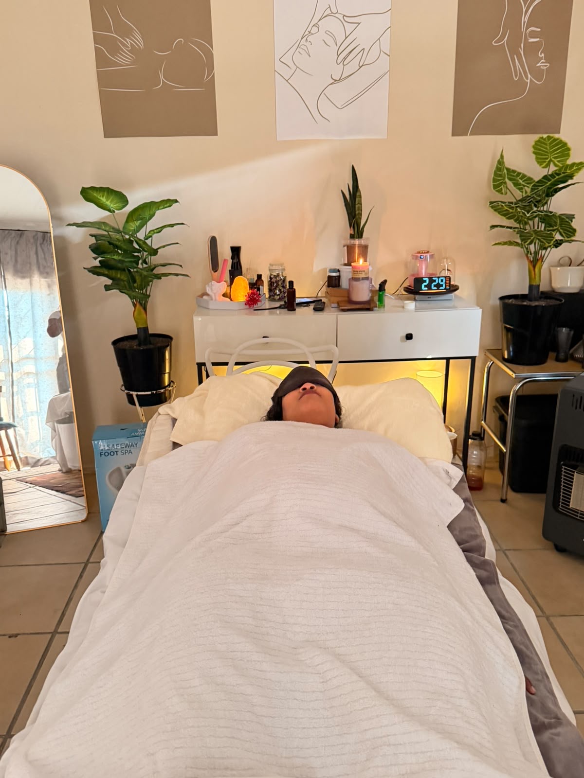 A client resting with an eye mask during a treatment